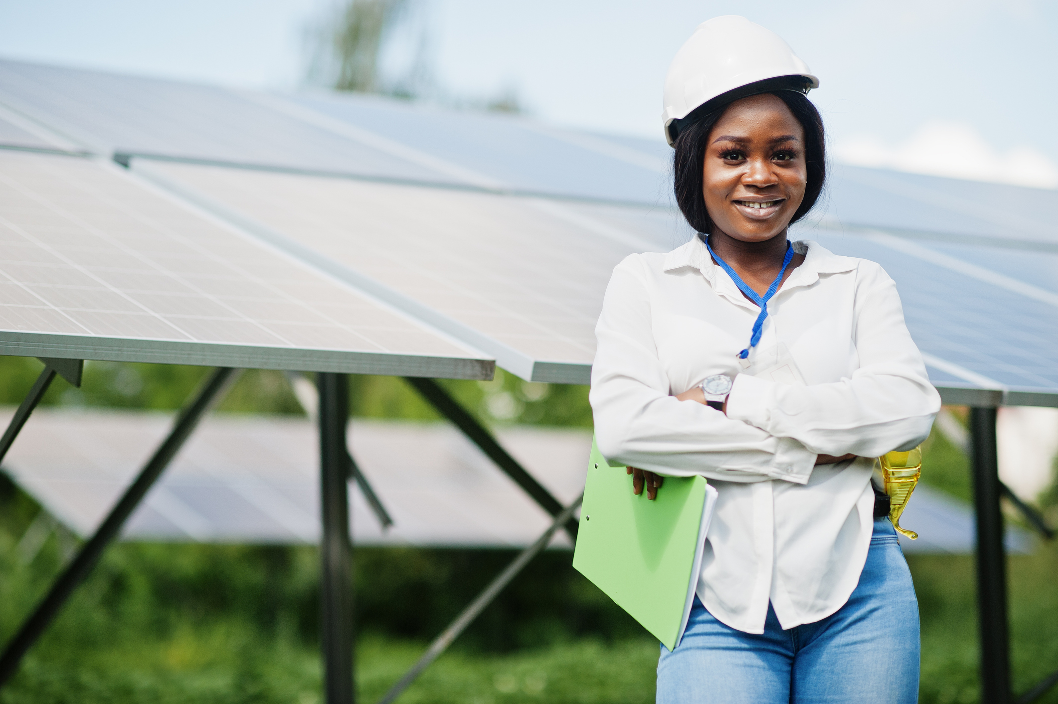 Female solar engineer standing in front of a solar array.