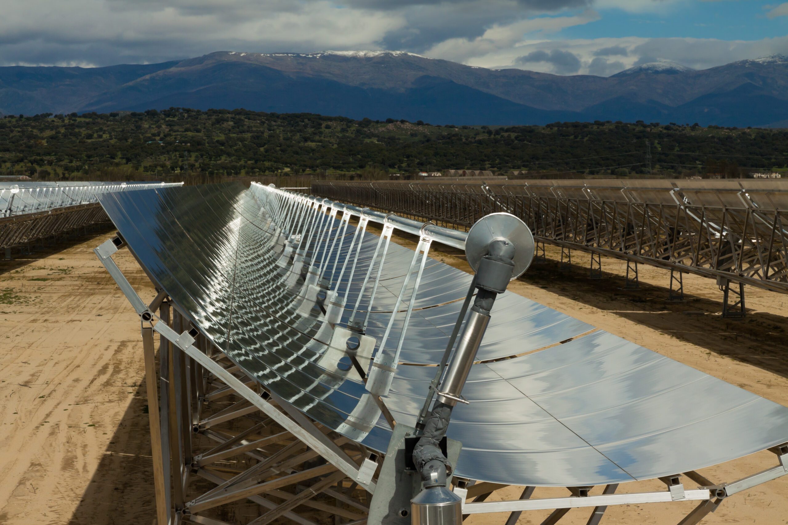A parabolic trough collector directing solar energy to generate CSP.