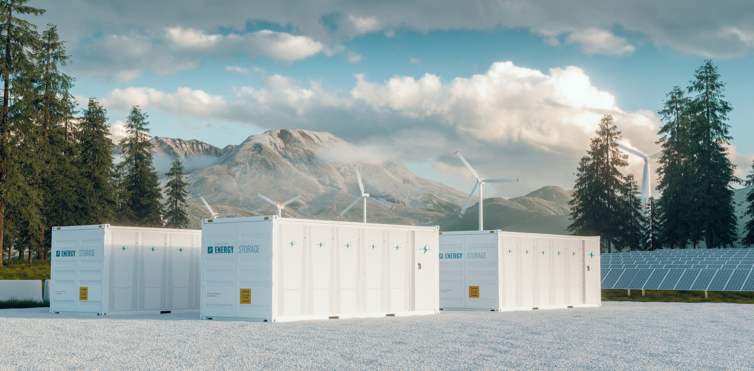 Utility-scale batteries in a solar and wind farm with mountains in the background